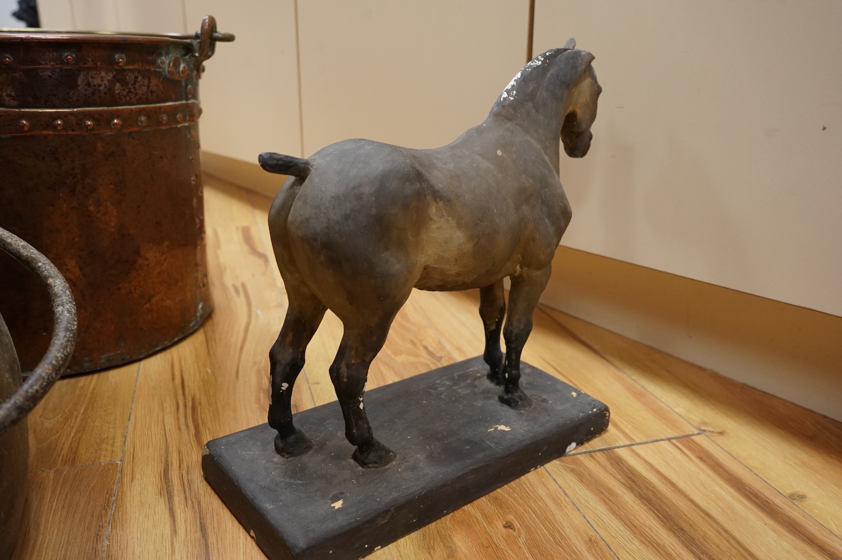 Two copper vessels and a plaster model of a horse
